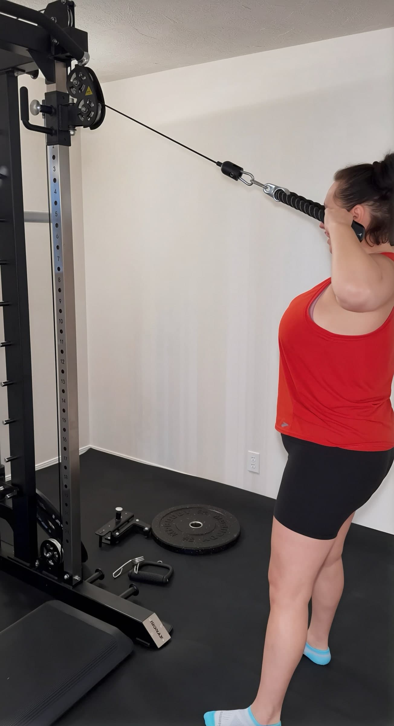 Client using a cable machine attachment during a coached personal training session.