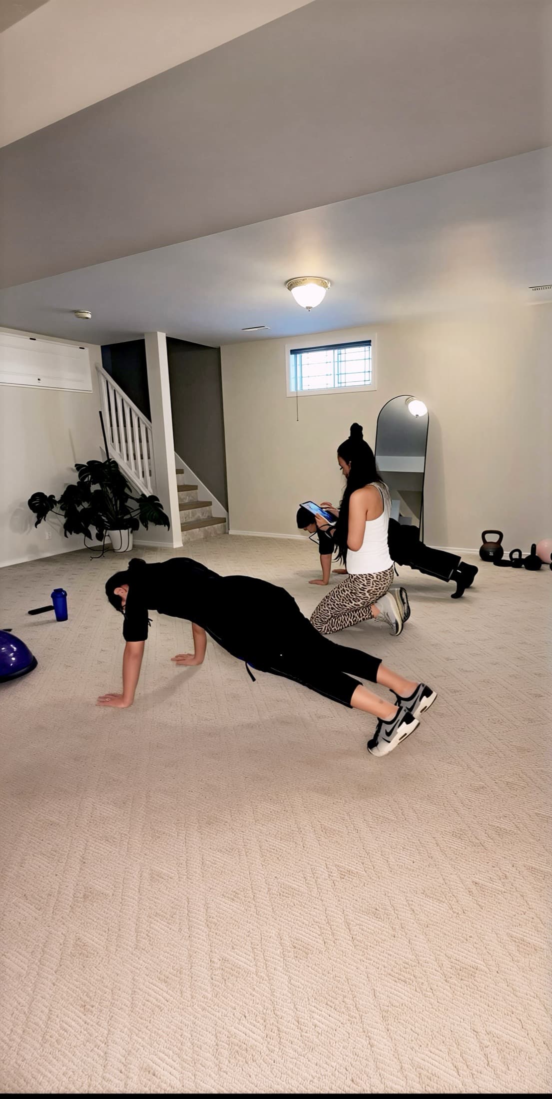 Mahnaz guiding clients through a small group bodyweight training session.